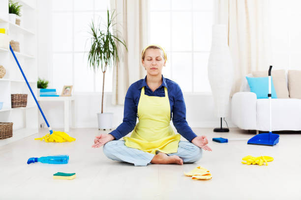 Woman relax with yoga exercise after hard cleaning work