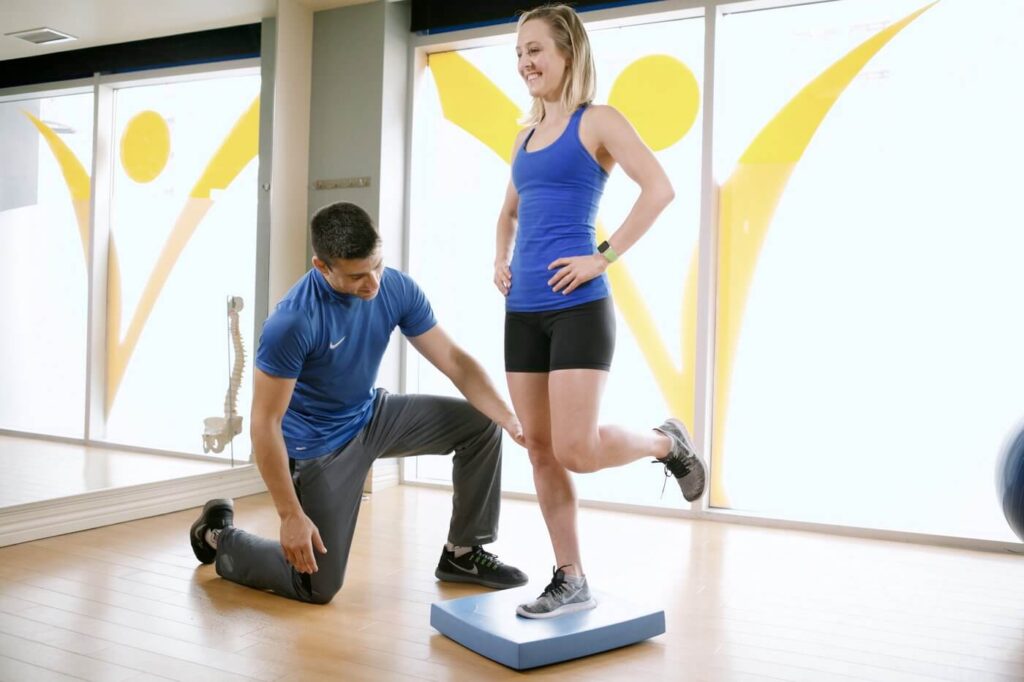 Physiotherapist assisting patient with exercise
