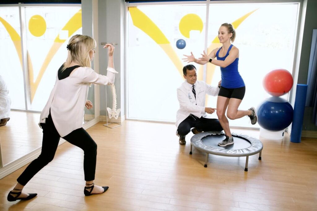 Image of physiotherapist and patient participating in a balance and coordination functional exercise
