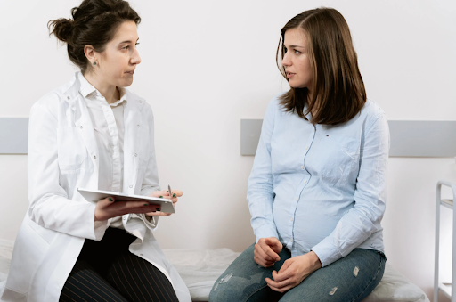healthcare professional talking to pregnant woman