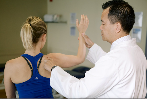 male using hands to help guide patient’s shoulder movement