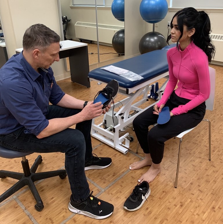 a podiatrist giving footwear advice to a patient