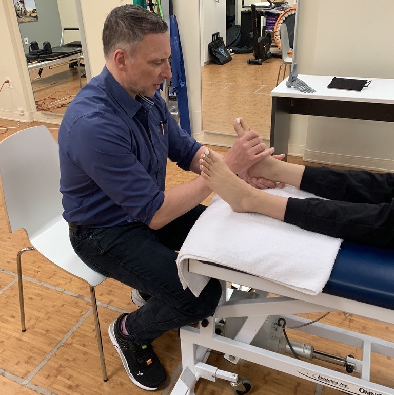 a podiatrist examining a patient's foot